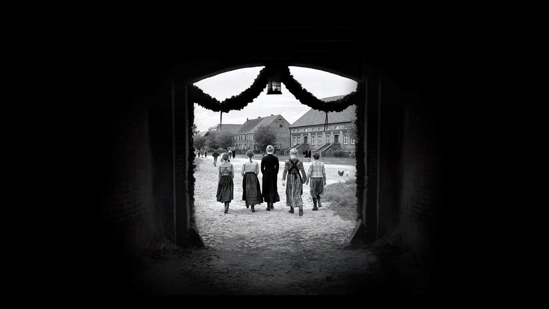 Children wearing white ribbons in a Protestant village; forensic black-and-white frames the weaponization of "purity" — Haneke's "The White Ribbon" (2009).